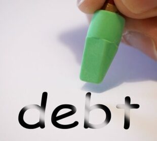 debt being erased on a piece of paper by ahand holding a pencil