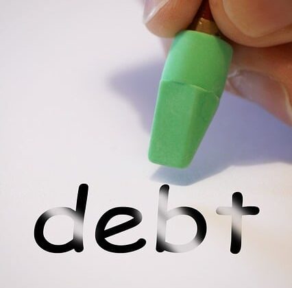 debt being erased on a piece of paper by ahand holding a pencil